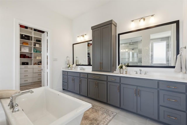 3411 Torrance Blvd, Frisco, TX 75034 - full bath with a freestanding bath, double vanity, a walk in closet, and tile patterned floors