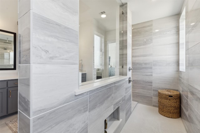 3411 Torrance Blvd, Frisco, TX 75034 - full bath featuring tile walls, tiled shower, vanity, and tile patterned flooring