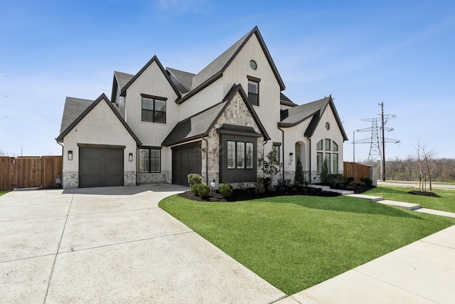 3411 Torrance Blvd, Frisco, TX 75034 - french country home featuring concrete driveway, brick siding, roof with shingles, stone siding, and an attached garage