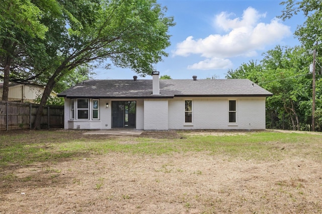 back of property featuring brick siding