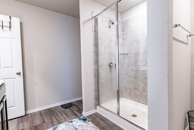 2358 Aylesbury Dr, Copperas Cove, TX 76522 - bathroom with a stall shower, wood finished floors, and baseboards