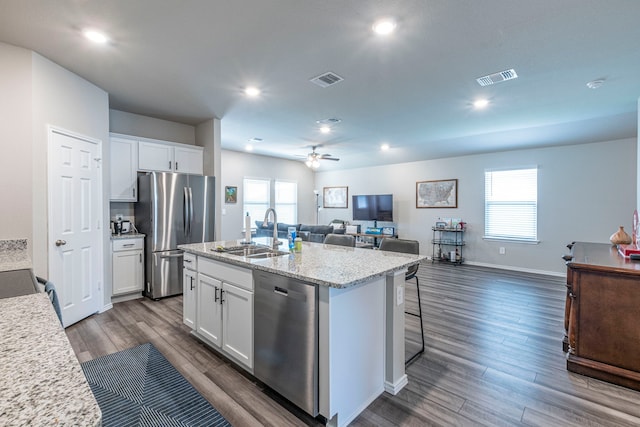 2358 Aylesbury Dr, Copperas Cove, TX 76522 - kitchen featuring stainless steel appliances, a sink, open floor plan, white cabinets, and a center island with sink