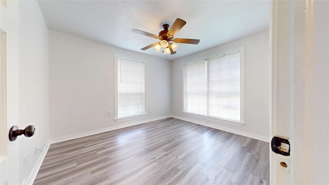 1107 Vine St, Weatherford, TX 76086 - spare room with wood finished floors, baseboards, and ceiling fan