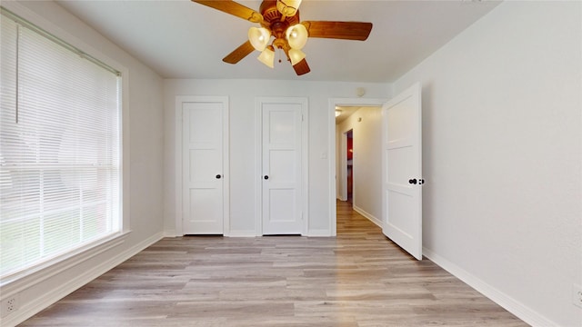 1107 Vine St, Weatherford, TX 76086 - unfurnished bedroom featuring light wood-type flooring, baseboards, and ceiling fan