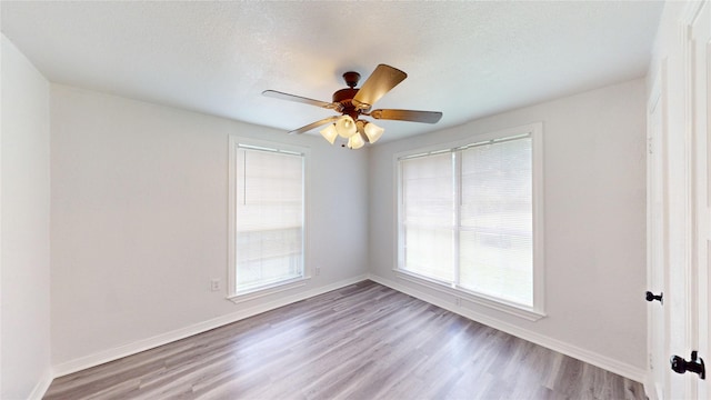 1107 Vine St, Weatherford, TX 76086 - empty room featuring light wood-type flooring, baseboards, a ceiling fan, and a textured ceiling