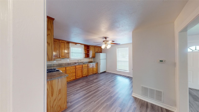 1107 Vine St, Weatherford, TX 76086 - kitchen featuring freestanding refrigerator, wood finished floors, baseboards, a ceiling fan, and a textured ceiling