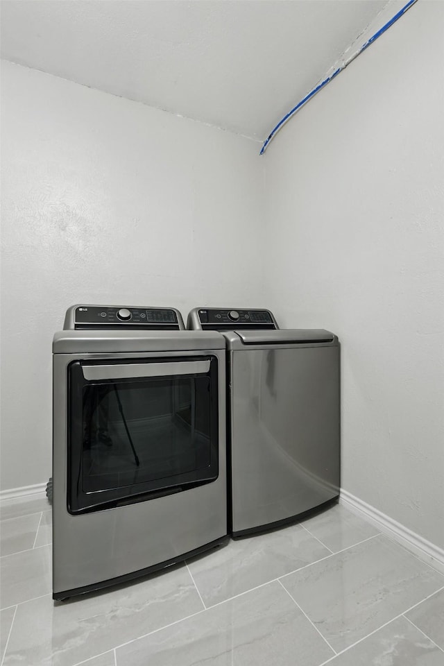 2433 Loyce Dr, Mesquite, TX 75149 - laundry room with washer and dryer and baseboards