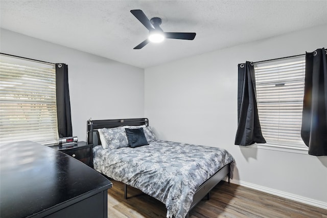 2433 Loyce Dr, Mesquite, TX 75149 - bedroom with baseboards, wood finished floors, a textured ceiling, and ceiling fan