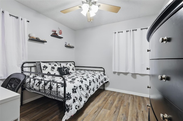 2433 Loyce Dr, Mesquite, TX 75149 - bedroom with baseboards, wood finished floors, and ceiling fan