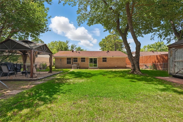 2433 Loyce Dr, Mesquite, TX 75149 - back of house featuring a gazebo, brick siding, central AC, and a patio