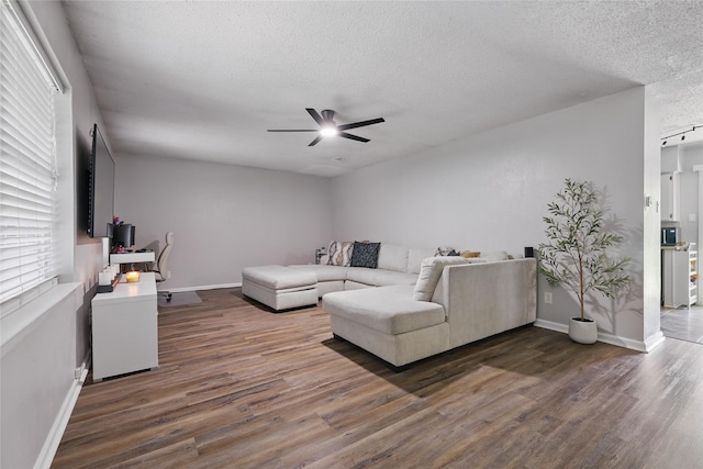 2433 Loyce Dr, Mesquite, TX 75149 - living area featuring ceiling fan, a textured ceiling, wood finished floors, baseboards, and plenty of natural light