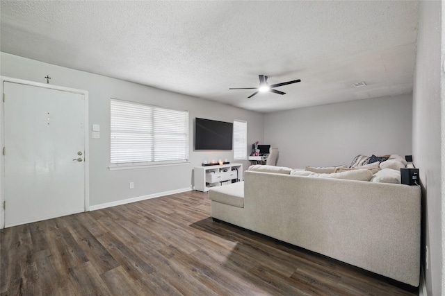 2433 Loyce Dr, Mesquite, TX 75149 - living area featuring a ceiling fan, dark wood-style flooring, a textured ceiling, and baseboards