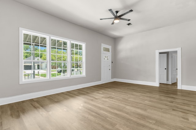 1315 E Pecan St, Gainesville, TX 76240 - unfurnished living room with baseboards, ceiling fan, and light wood-style flooring