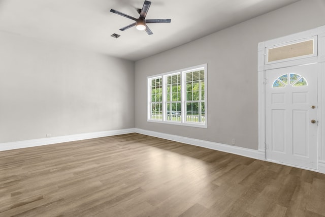 1315 E Pecan St, Gainesville, TX 76240 - foyer with plenty of natural light, wood finished floors, ceiling fan, and baseboards