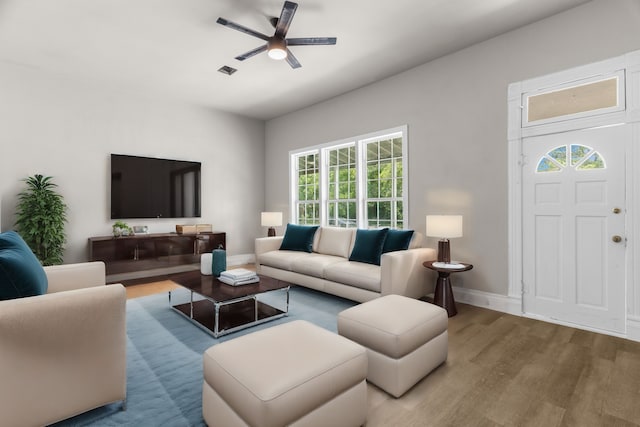 1315 E Pecan St, Gainesville, TX 76240 - living room with wood finished floors, a ceiling fan, and baseboards