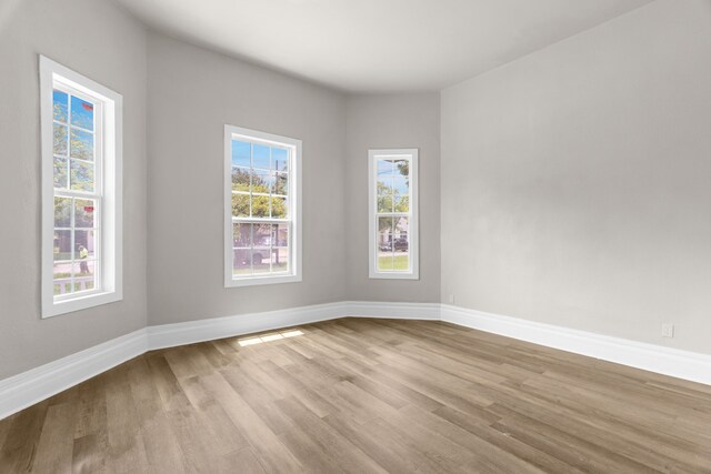 1315 E Pecan St, Gainesville, TX 76240 - spare room featuring wood finished floors and baseboards