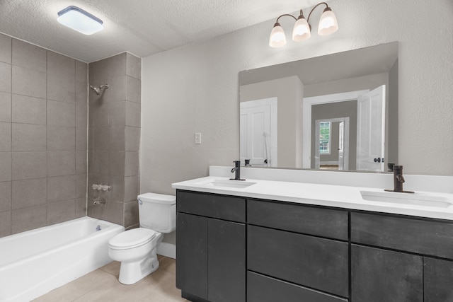 1315 E Pecan St, Gainesville, TX 76240 - bathroom featuring toilet, a textured ceiling, double vanity, shower / washtub combination, and a textured wall