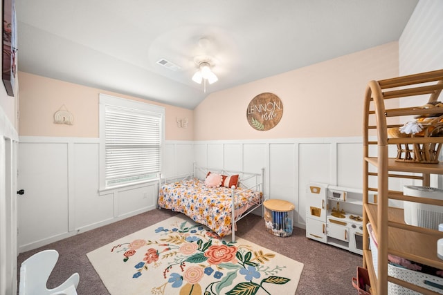 1917 Campground Way, Aubrey, TX 76227 - carpeted bedroom featuring wainscoting, a decorative wall, vaulted ceiling, and a ceiling fan