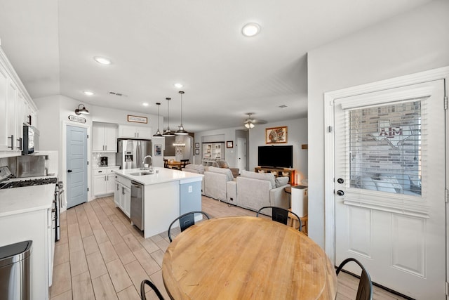 1917 Campground Way, Aubrey, TX 76227 - kitchen with stainless steel appliances, ceiling fan, white cabinets, light countertops, and open floor plan