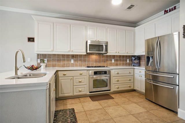 6008 Thistle Way, Denton, TX 76210 - kitchen featuring stainless steel appliances, a sink, backsplash, light countertops, and white cabinetry