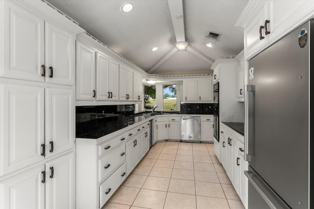 3438 N US Highway 271, Mount Pleasant, TX 75455 - kitchen featuring stainless steel appliances, light tile patterned floors, dark countertops, decorative backsplash, and white cabinets