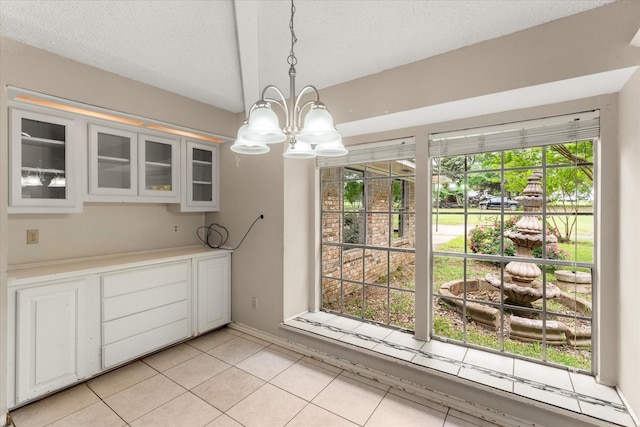 3438 N US Highway 271, Mount Pleasant, TX 75455 - unfurnished dining area featuring a chandelier, plenty of natural light, light tile patterned flooring, a textured ceiling, and baseboards