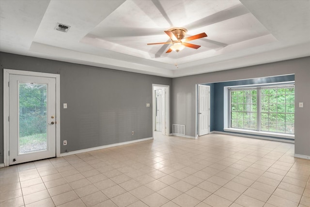 3438 N US Highway 271, Mount Pleasant, TX 75455 - unfurnished room with a raised ceiling, ceiling fan, baseboards, and healthy amount of natural light