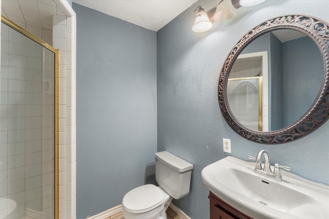 3438 N US Highway 271, Mount Pleasant, TX 75455 - bathroom featuring toilet, a tile shower, baseboards, and vanity