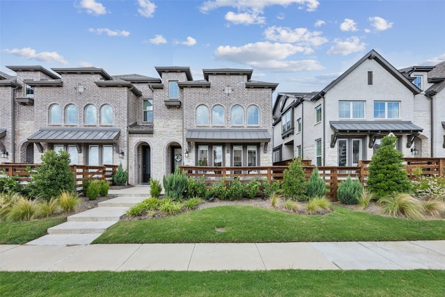 424 Somerville Dr, Mckinney, TX 75071 - view of front of home featuring fence, a standing seam roof, and brick siding