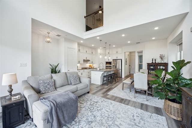 424 Somerville Dr, Mckinney, TX 75071 - living area with light wood-type flooring, recessed lighting, and a towering ceiling