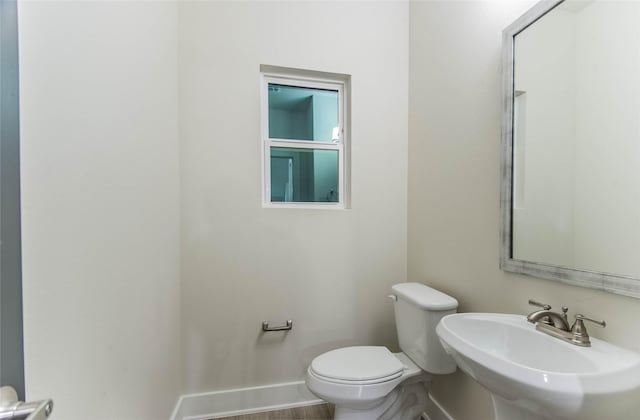 3325 Norris St, Plano, TX 75074 - half bathroom with toilet, a sink, and baseboards
