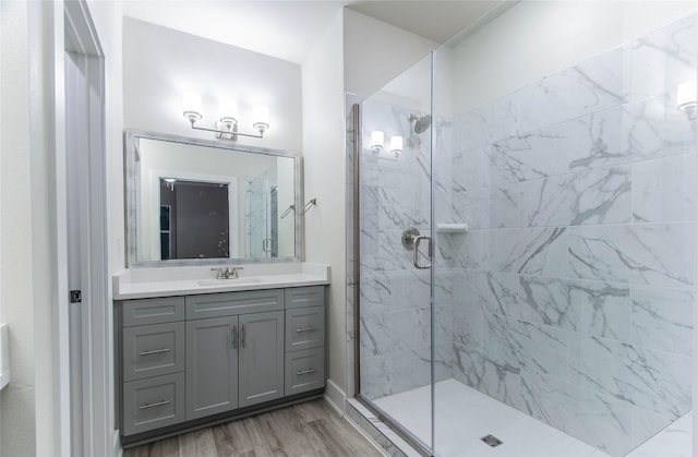 3325 Norris St, Plano, TX 75074 - bathroom featuring a tile shower, wood finished floors, and vanity