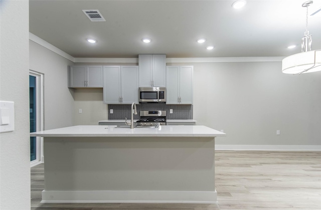 3325 Norris St, Plano, TX 75074 - kitchen featuring appliances with stainless steel finishes, a sink, light wood-type flooring, light countertops, and tasteful backsplash