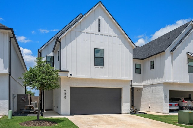 238 Estates Cir, College Station, TX 77840 - modern inspired farmhouse featuring board and batten siding, a garage, brick siding, roof with shingles, and driveway