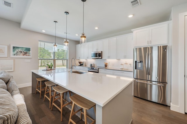 238 Estates Cir, College Station, TX 77840 - kitchen featuring appliances with stainless steel finishes, a sink, an island with sink, dark wood-type flooring, and recessed lighting