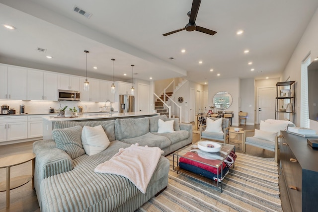 238 Estates Cir, College Station, TX 77840 - living area with stairway, a ceiling fan, and recessed lighting