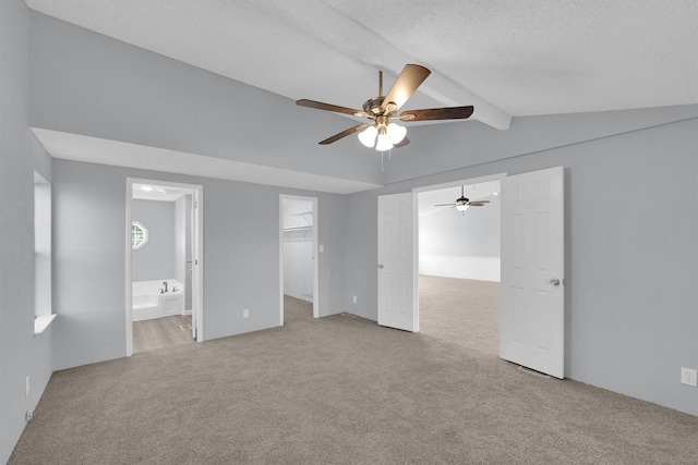 3355 La Mesa Dr, Weatherford, TX 76085 - unfurnished bedroom with carpet flooring, a textured ceiling, a spacious closet, ensuite bath, and ceiling fan