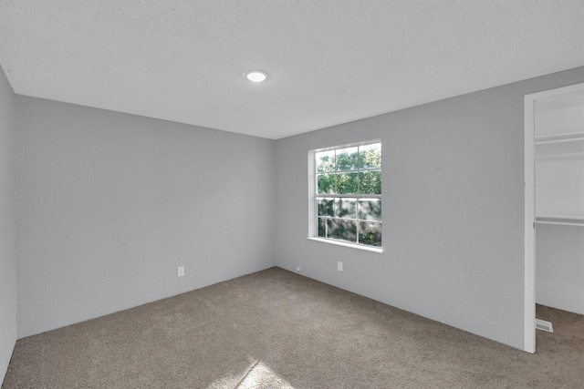 3355 La Mesa Dr, Weatherford, TX 76085 - unfurnished bedroom with carpet, a spacious closet, a closet, and recessed lighting