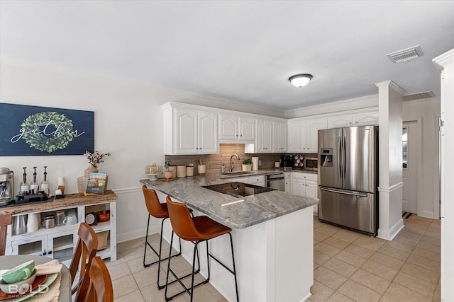 7622 Mary Ann Cir, Blanchard, LA 71107 - kitchen with appliances with stainless steel finishes, a sink, a peninsula, light tile patterned flooring, and white cabinets