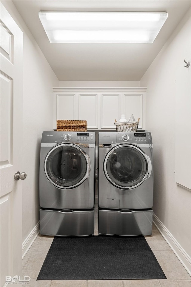 7622 Mary Ann Cir, Blanchard, LA 71107 - laundry room featuring cabinet space, washer and dryer, light tile patterned flooring, and baseboards