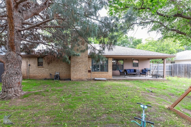3526 Carnation Ct, Abilene, TX 79606 - back of property featuring an outdoor living space, a patio area, brick siding, and a shingled roof