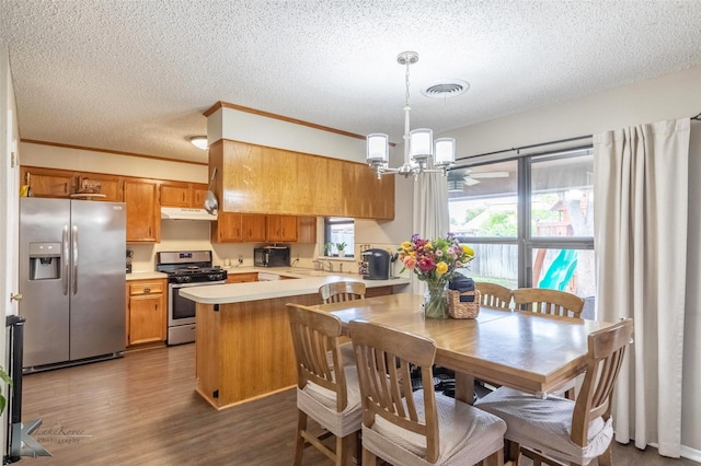 3526 Carnation Ct, Abilene, TX 79606 - dining space with a chandelier, a textured ceiling, dark wood finished floors, and crown molding