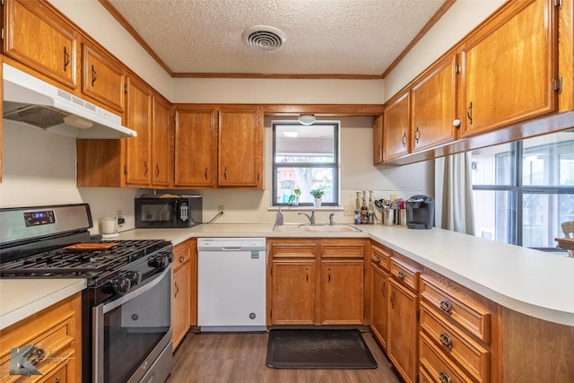 3526 Carnation Ct, Abilene, TX 79606 - kitchen with gas stove, dishwasher, black microwave, under cabinet range hood, and dark wood finished floors
