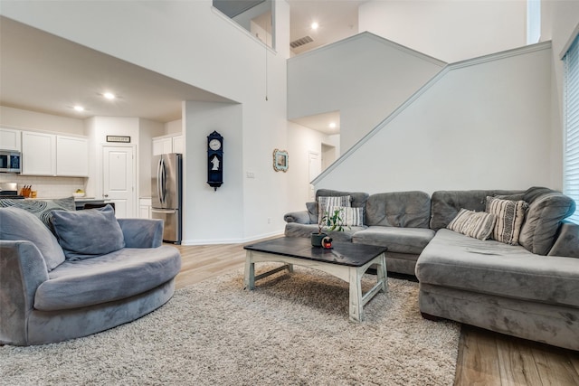 1252 Milfoil Dr, Justin, TX 76247 - living area featuring light wood-type flooring, recessed lighting, baseboards, and a high ceiling