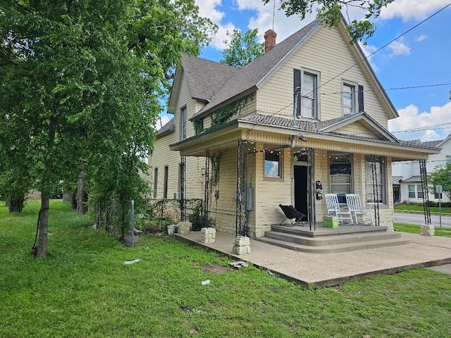 1801 S 10th St S Unit A & B, Waco, TX 76706 - view of front of home featuring a porch, a front yard, roof with shingles, and a chimney