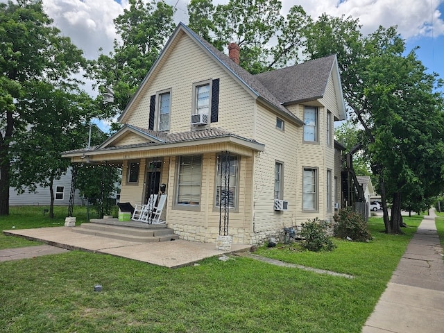 1801 S 10th St S Unit A & B, Waco, TX 76706 - view of front of property with a front yard, a chimney, covered porch, roof with shingles, and cooling unit
