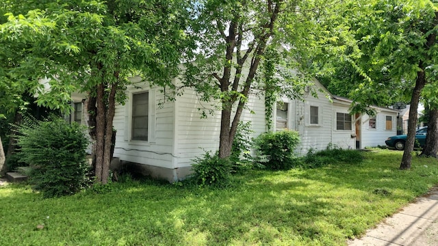 view of side of home featuring a yard