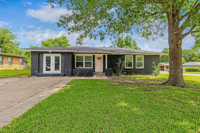 1701 W College St, Sherman, TX 75092 - view of front of property with brick siding, a front yard, and french doors