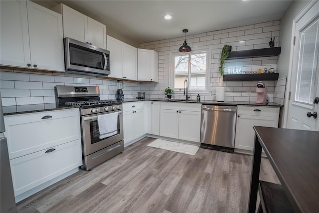 1701 W College St, Sherman, TX 75092 - kitchen featuring stainless steel appliances, backsplash, light wood-style floors, white cabinetry, and recessed lighting