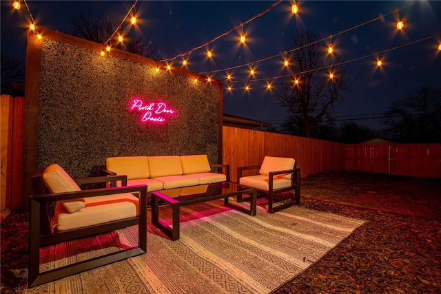 1701 W College St, Sherman, TX 75092 - patio at night featuring an outdoor living space and a fenced backyard